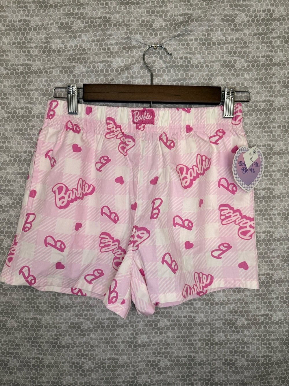 Barbie pink shorts with repeating pink 'Barbie' text and hearts, size L
